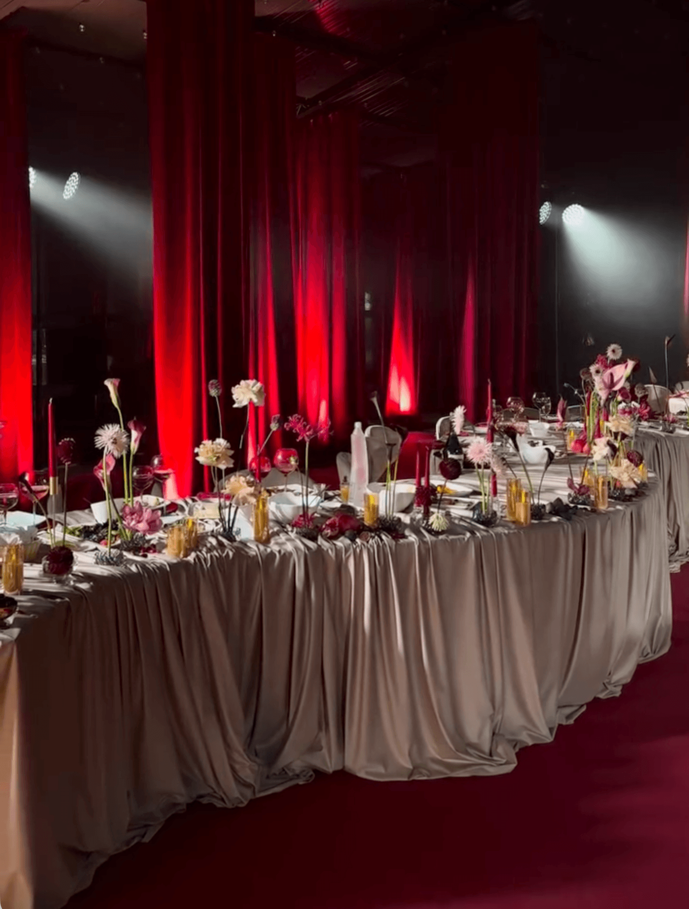 Elegant red-lit wedding reception